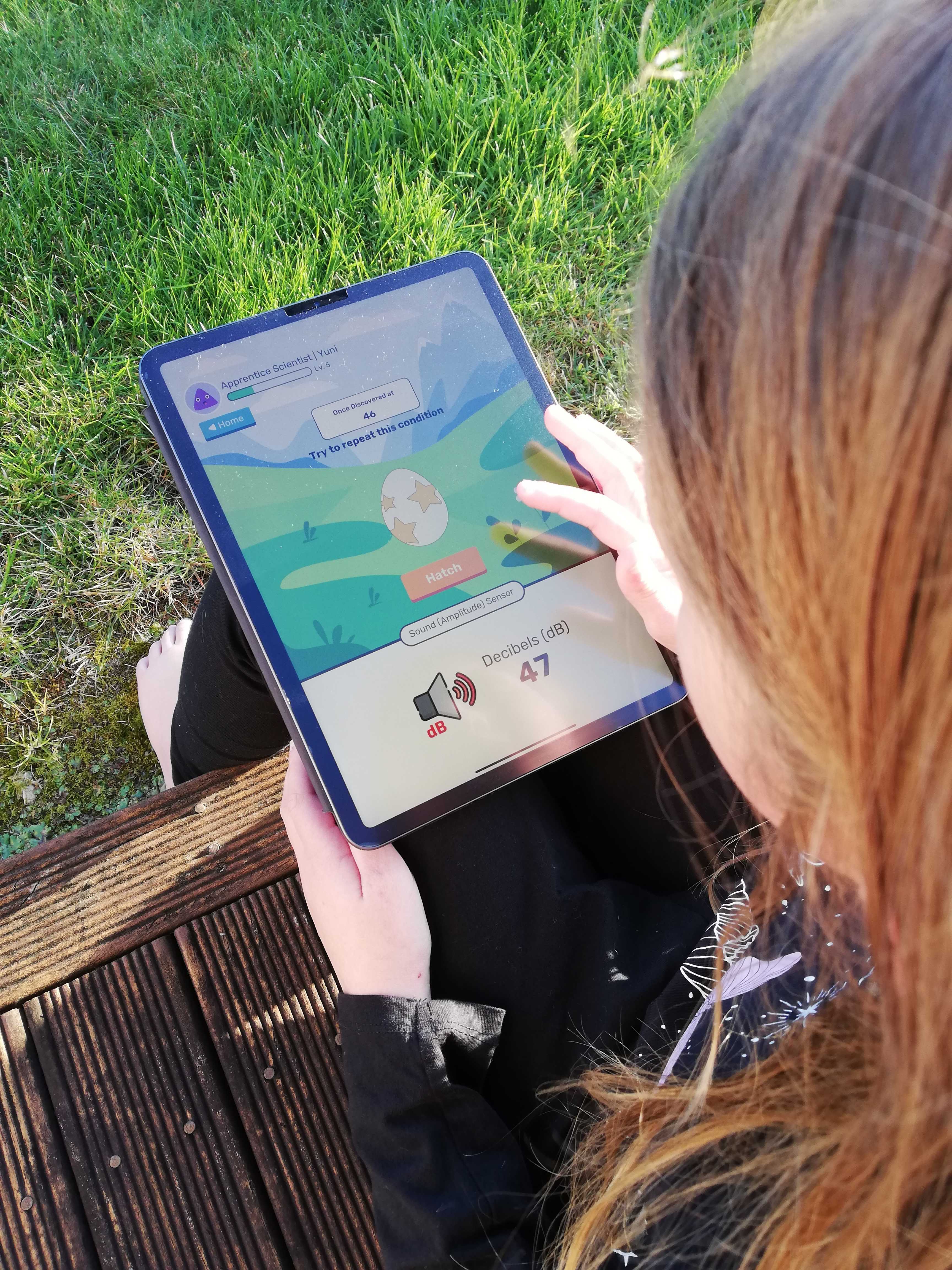 Screenshot of the Hopu app and a child playing the mobile game on an ipad